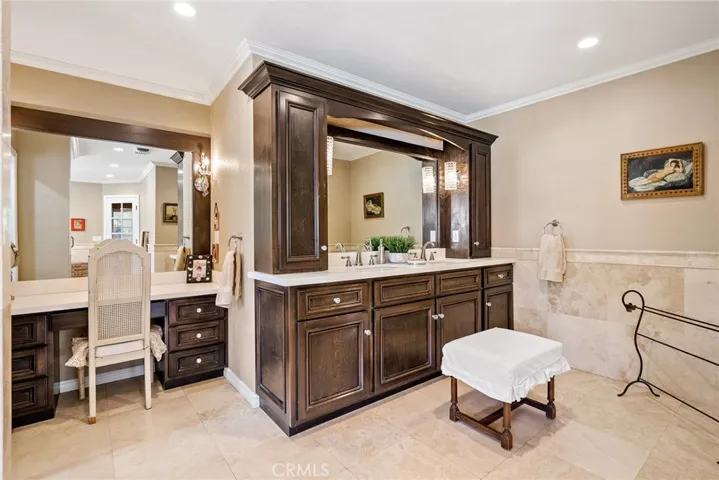 Main bathroom with custom cabinetry, double sink