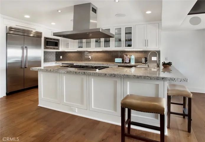Equipped with Thermador appliances, stone countertops and wine refrigerator