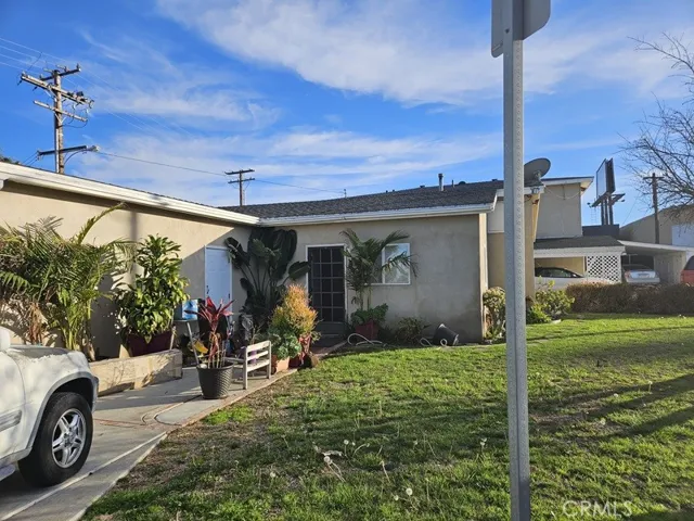 Single-Story House With Front Lawn, Driveway, And Garage