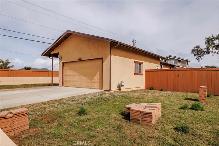 Newer concrete driveway and oversized garage with 10 ft ceilings