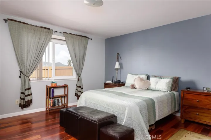 Primary bedroom 13.5 ft x 13.5 ft with Koa Hardwood flooring.