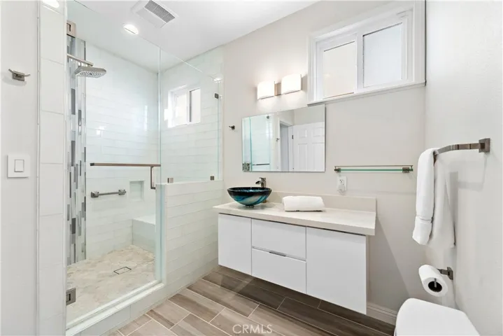 New downstairs custom full bath with arched glass wall.