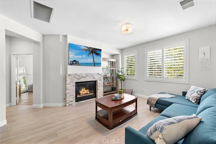 Cozy family room with fireplace and plantation shutters.
