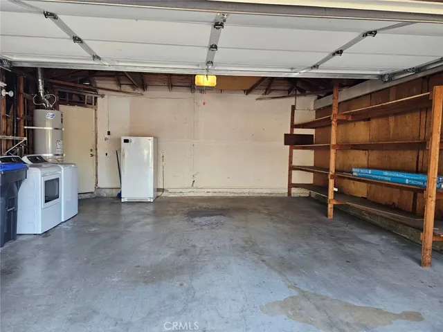 Enclosed Garage with washer and dryer, freezer, and lots of shelves