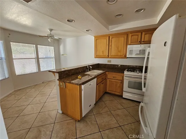 View of Kitchen with nook and window view to private court yard in front of home.