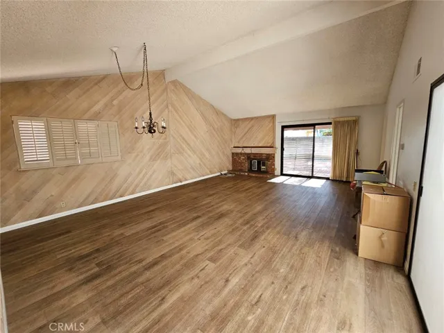 Dining and Living room with vaulted ceilings, fireplace, plank flooring