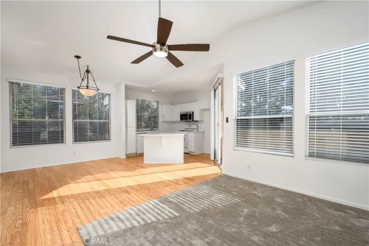 Open Concept Living/Dining Rooms and Kitchen.  Large dual paned windows provide plenty of natural light and great views of the surrounding community, trees, and skyline!