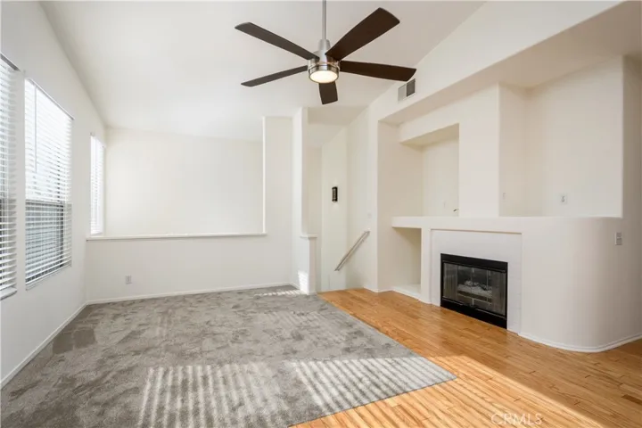 Large Living Room Cathedral Ceilings, Ceiling Fan, NEW interior paint, refinished hardwood flooring, NEW carpet, and fireplace!