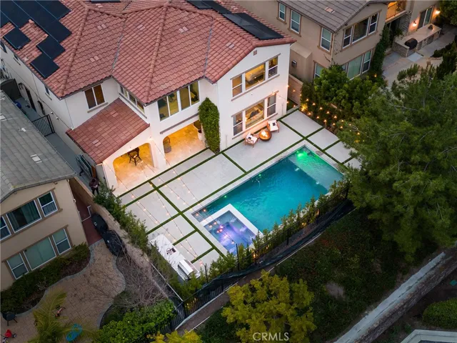 New custom pool and spa, barbecue and covered California room with bar that opens into the home.