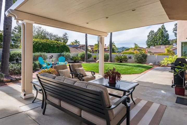 Solid aluminum patio cover has lights and pull down shade cover.