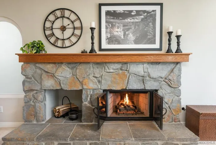 Custom family room fireplace has been converted to gas log system. Upgraded grates and mantle add class.
