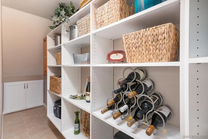 Walk-in pantry is deep and has additional storage cupboards and locking cabinet.