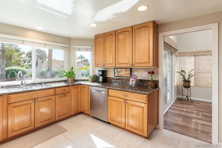 Granite counters with maple cabinetry and windows to rear yard.