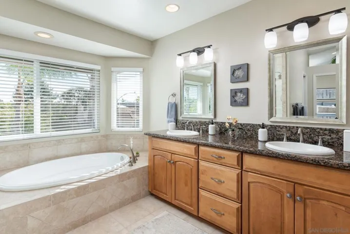 Primary bath has dual basins, soaking tub, private toilet room and shower.