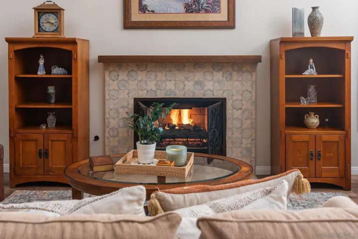 Hand crafted fireplace tiles from Arto.  Fireplace has been converted to gas log system with classy iron grates.