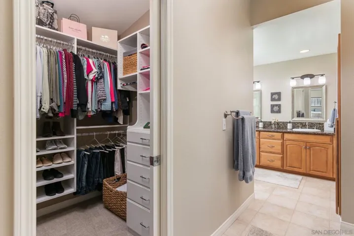 Primary has walk-in closet with pocket door. It is lit and has a solatube.  Closet organizer system conveys. There is a secondary closet not pictured.