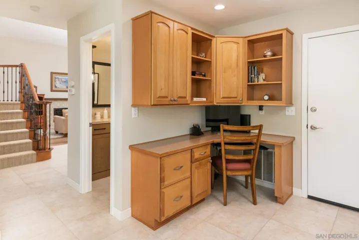 Custom built-in desk station has upper and lower cabinetry.