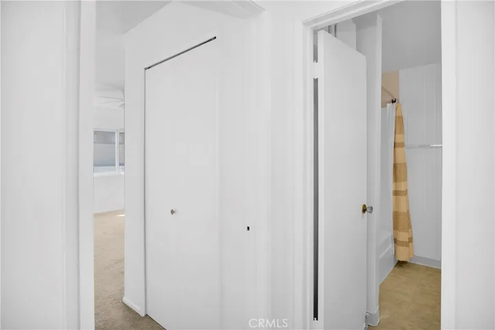 View of bathroom entrance and bedroom second closet