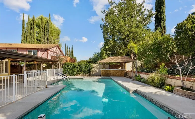 safety gated pool with tiki bar