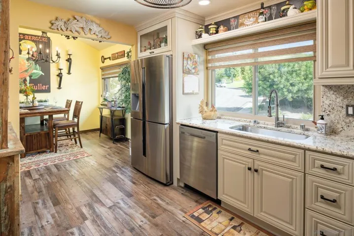 Actual color. Entries were widened to dining area. Custom kitchen with upper shelving & glass face cabinets.