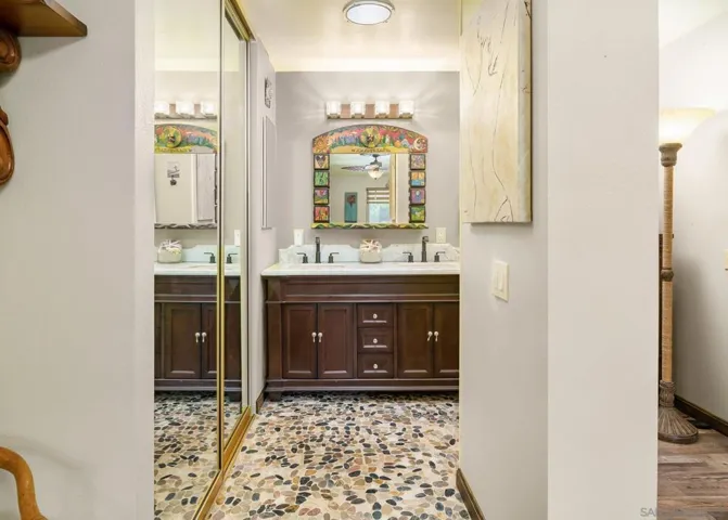 Virtually painted. River rock stone flooring and dual basins.