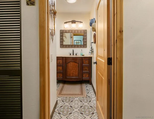 Hall wall is virtually painted. Bathroom is actual. Second bath has authentic Italian tile flooring.