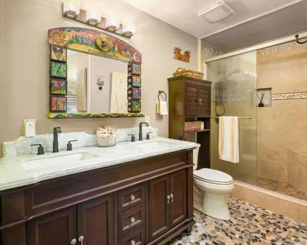 Virtually painted. Shower has bench seat, stone surround to ceiling and handheld spray. Counter surface is Carrera marble.