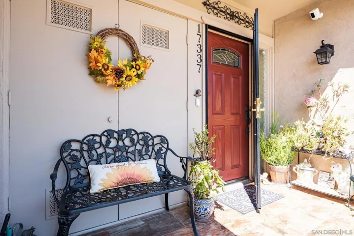 Custom screen door and front door. Tiled patio.