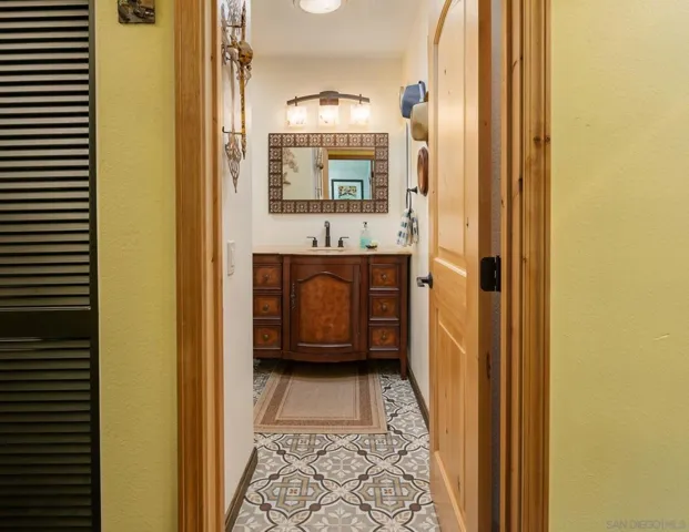 Hall wall is virtually painted. Bathroom is actual. Second bath has authentic Italian tile flooring.