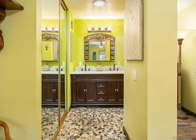 Actual color.  River rock stone flooring and dual basins.