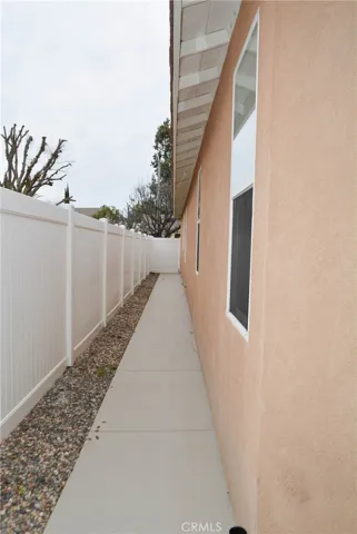 Both sides of the house in the rear have cement walkways