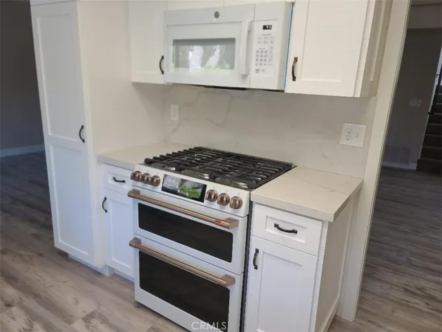 New kitchen cabinets and new 6 burner stove with double oven, air fryer option& temperature probe roasting with built in carousel microwave above.