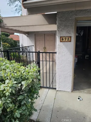 Gated entrance to double doors.