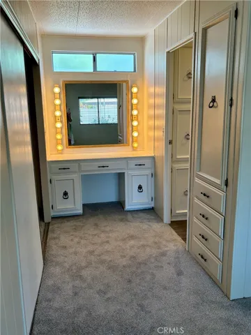 Primary bedroom vanity and closet area