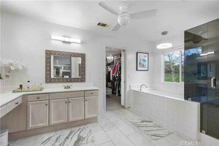 Primary bathroom is spacious with upgraded tile flooring!