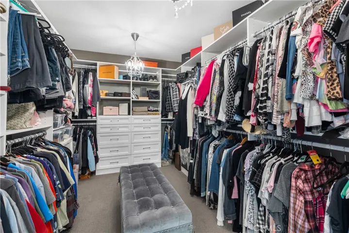 Primary bathroom has Walk-in wardrobe closet with California Closets built-in organizers!
