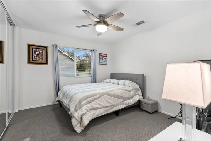 Ceiling fan and mirrored wardrobe closet doors in secondary bedroom!