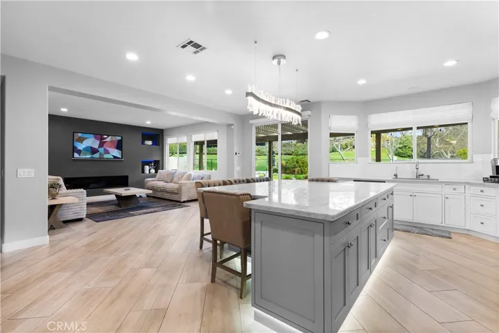 Kitchen open to family room!Kitchen island seats 5 and has elegant LED decorative overhead lighting!