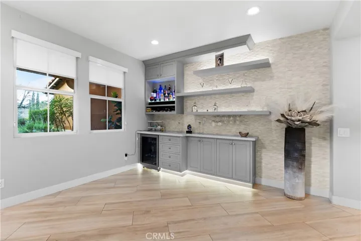 Quartz top custom bar with wine cooler  and floating shelves!