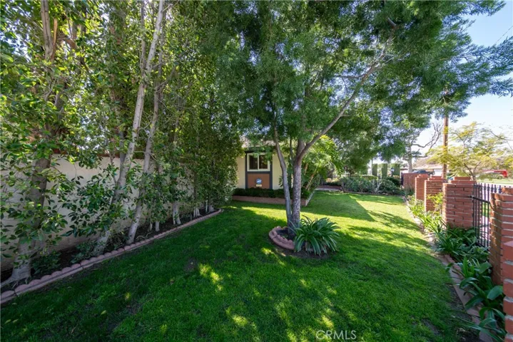 Landscaped Front yard. Security Gate. Alarm and Camera System.