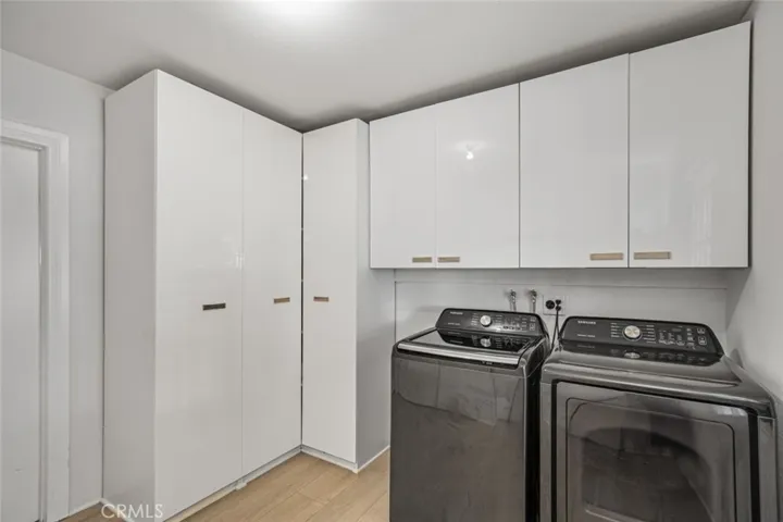 Large indoor laundry room with plenty of storage.