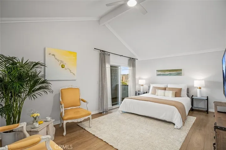 Large spacious primary bedroom with vaulted ceilings and a private balcony to retreat to.