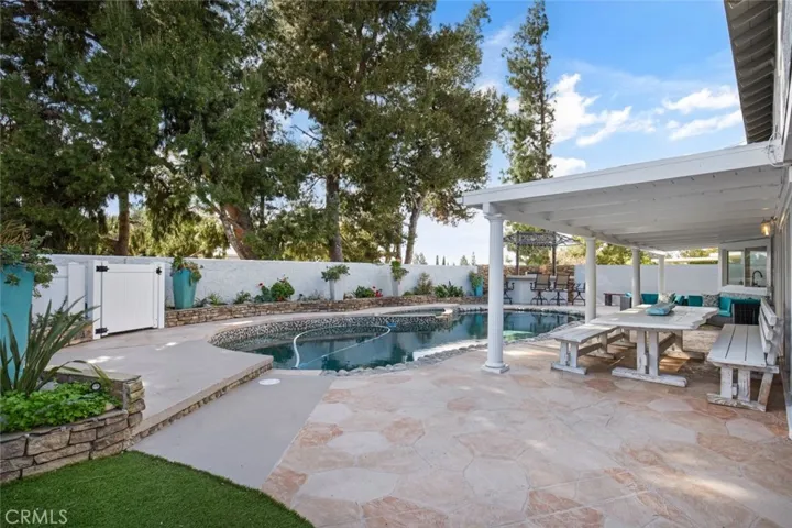 Large backyard with pool, spa and covered patio space.