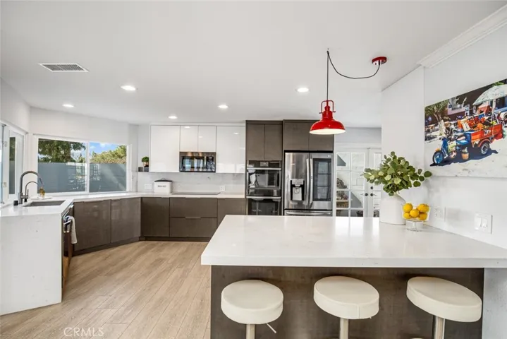 Beautifully remodeled kitchen with modern details and eating area with plenty of storage.
