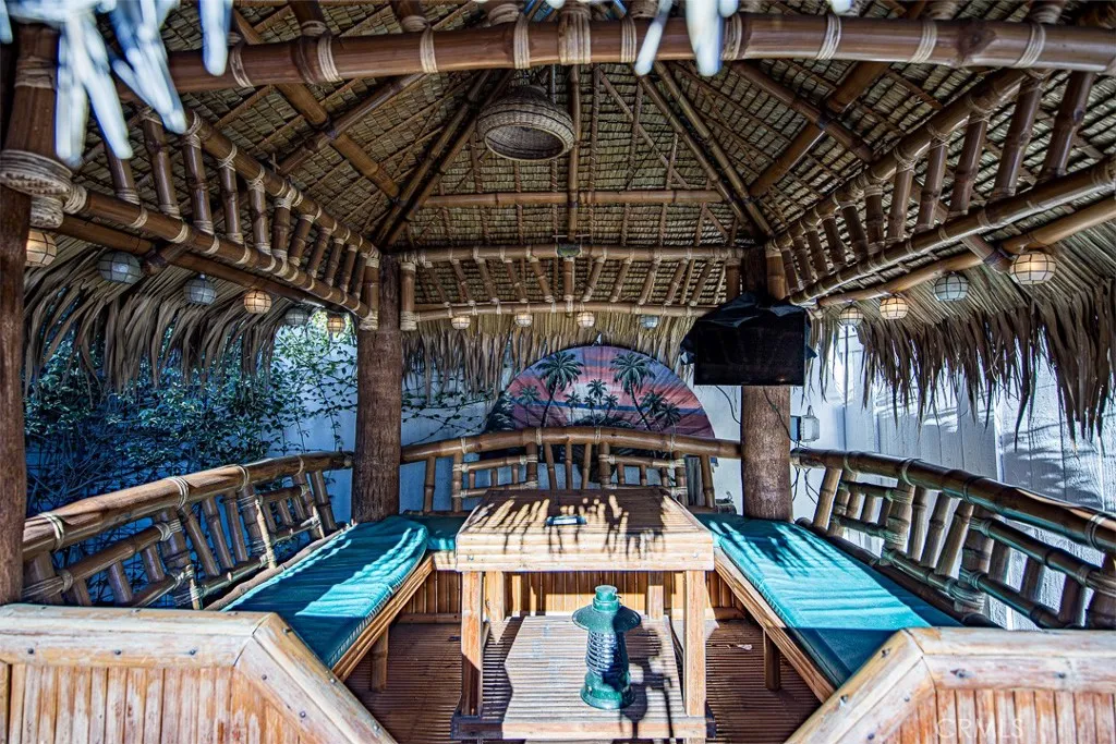 Tiki Hut with Seating, Table, and Mounted TV
