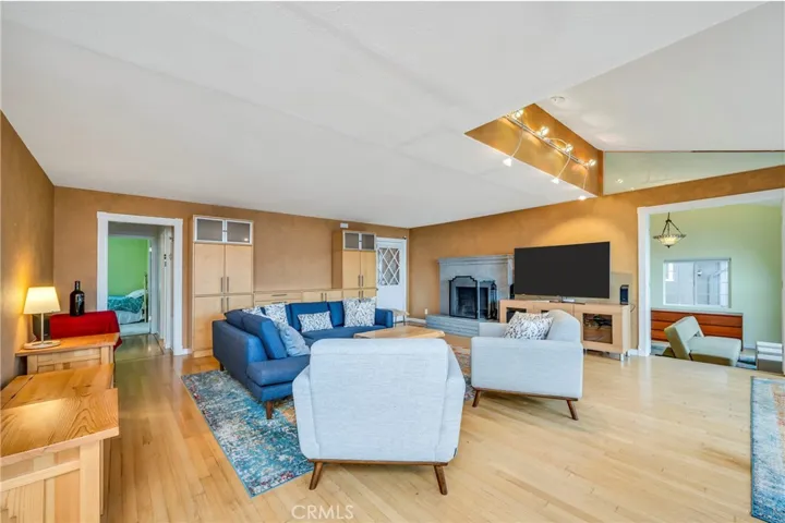 Living room and it shows how it opens to the primary bedroom on right, and other bedrooms on left