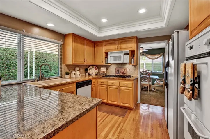 The Kitchen Boasts Granite Countertops, Travertine Backsplash