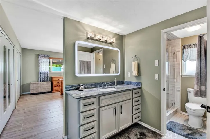 Modern Light Fixtures, Vanities with Quartz Countertops, and there is Even a Touch Sensor LED Light-Up Mirror in the Primary Suite Bath
