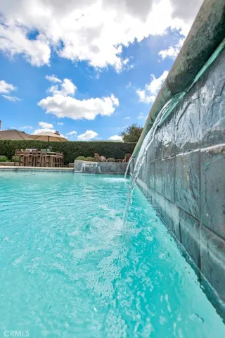 Sparkling Saltwater Pool with  1 of 2 Waterfalls Located on the Backside of the Pool