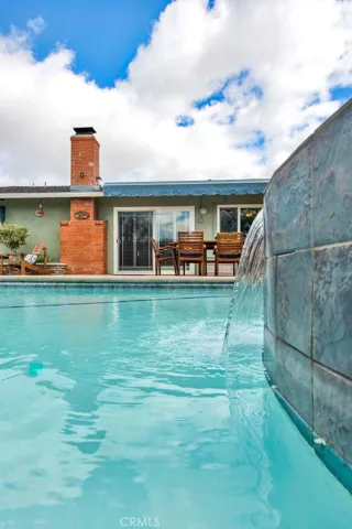 Sparkling Saltwater Pool with  1 of 2 Waterfalls Located Off the Spa